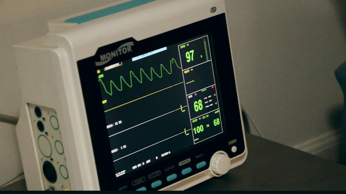 AirSense 11 CPAP machine with tube and mask set up on a bedside table