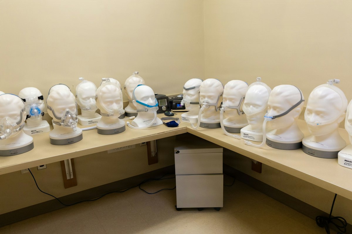 CPAP mask and tubing laid out for troubleshooting on a bedroom dresser