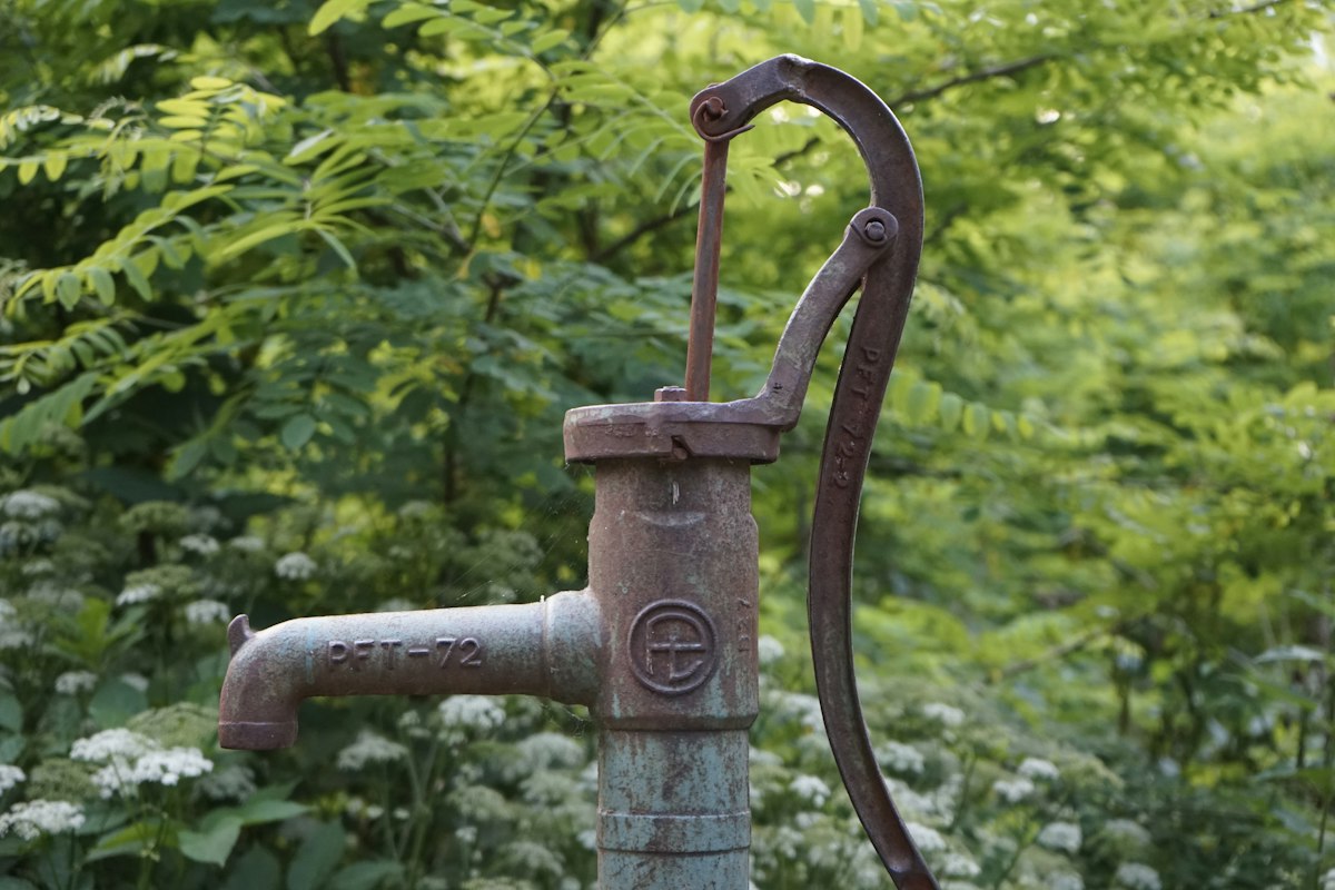 Private well head and pressure tank supplying rural drinking water