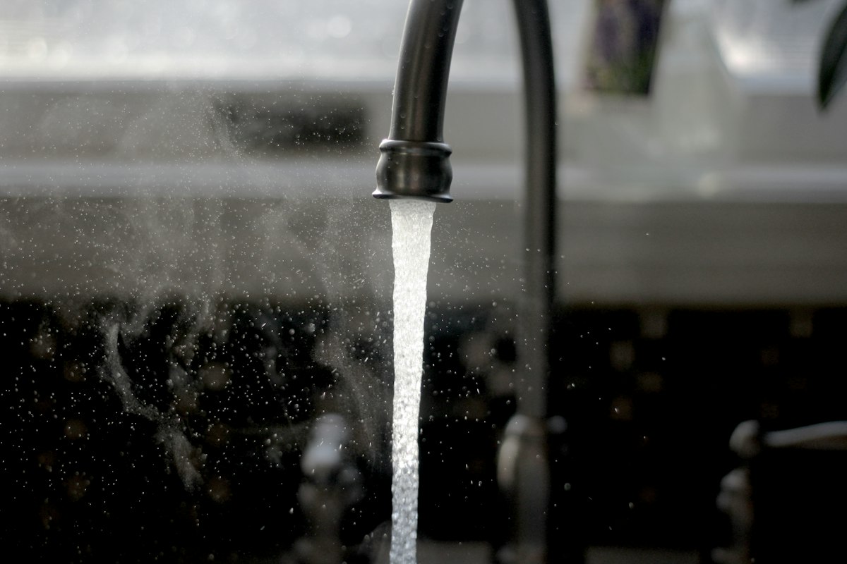 Under-sink reverse osmosis system installed below a kitchen sink
