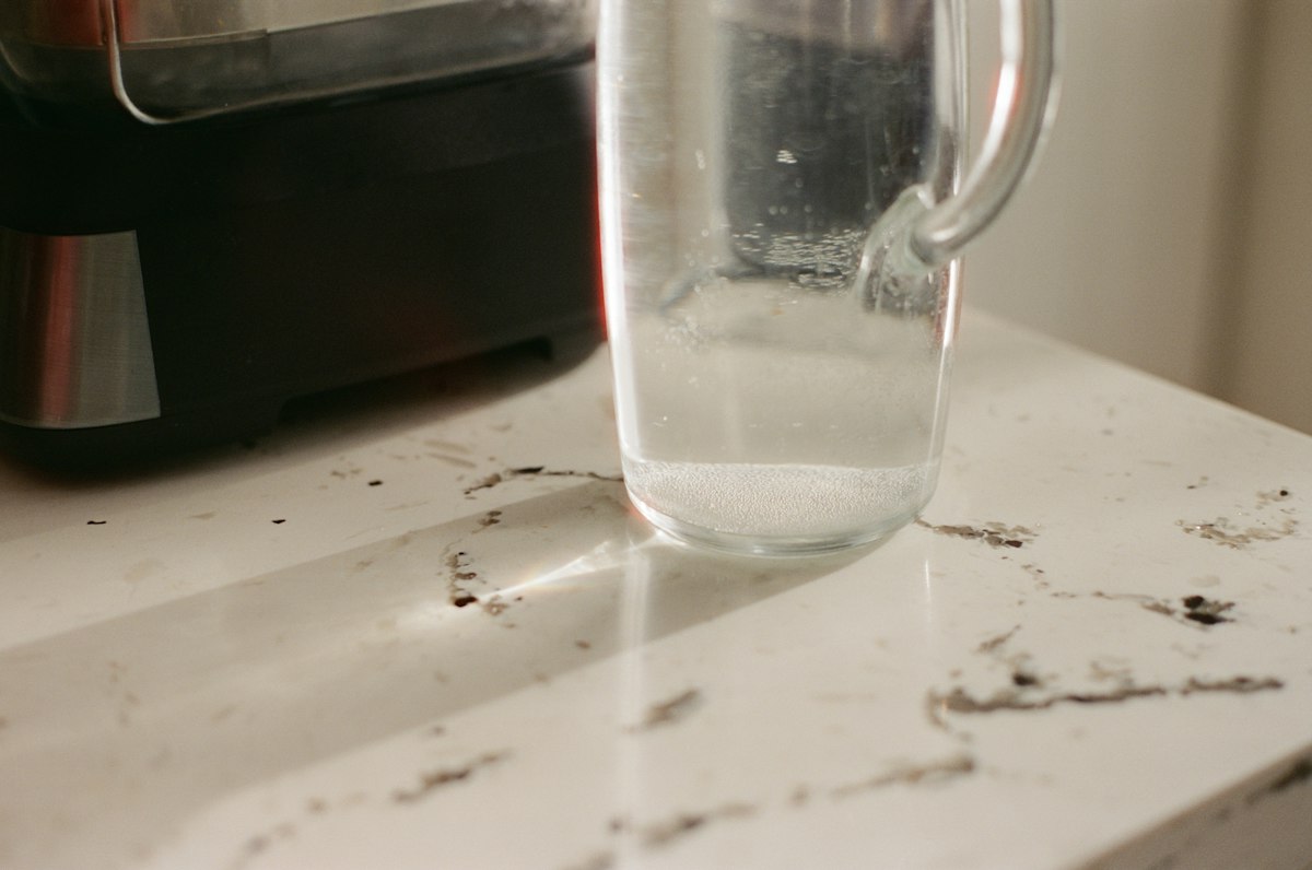 Clear glass pitcher with water on a countertop